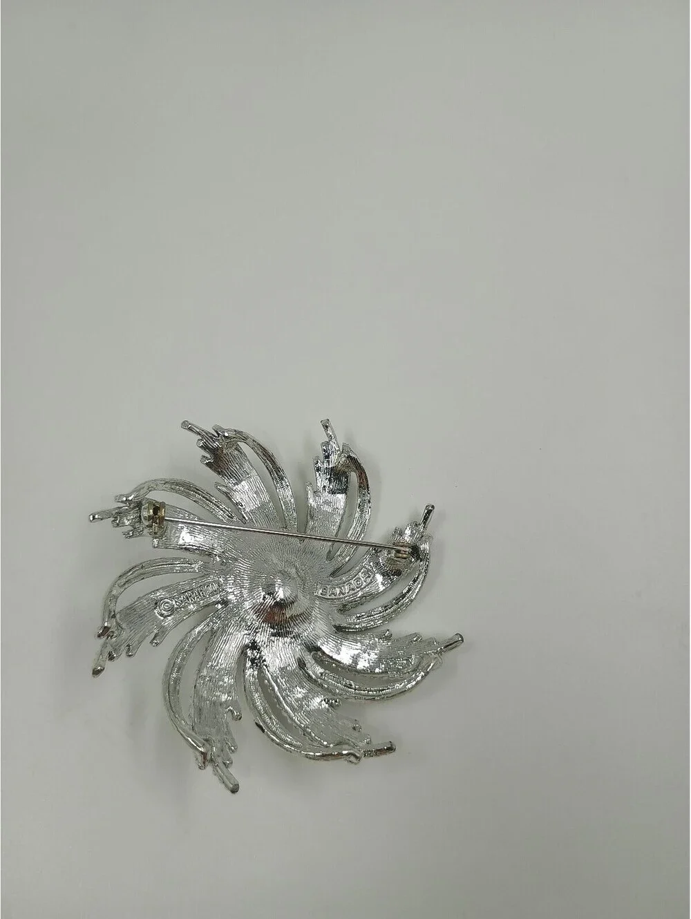 Elegant Silver-Tone Brooch with Pearl Center